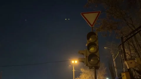 A non-working traffic light flashes yellow warning to stop and let traffic pass Stock Footage 302640346