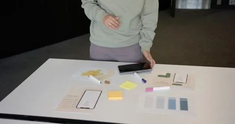 Nonbinary African designer after placing tablet laying mockup writing sticky Stock Footage 344673292