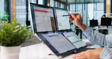 Nonprofit Manager Analyzes Donor Data On Laptop For Fundraising Planning. Stock Photos