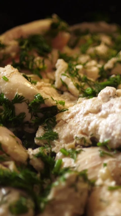 Nonstick plastic spatula flips sliced chicken breast in cast iron skillet. Stock Footage 263368406