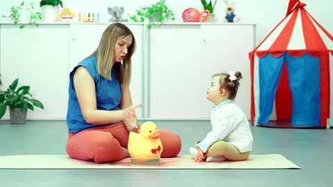 Nonverbal child with Down syndrome learning baby sign language. Stock Footage 303061895