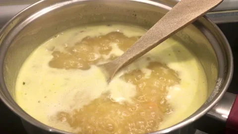 Noodle and vegetable soup simmering in a saucepan Stock Footage 142000853