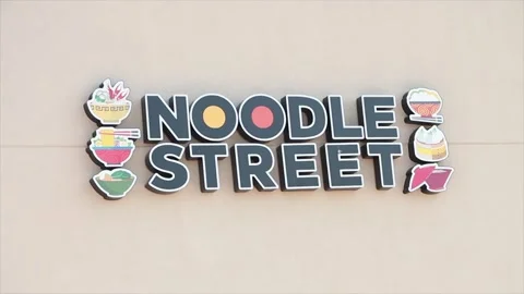 Noodle street writing caption text illustrated animated sign on light beige wall Stock Footage 249757020