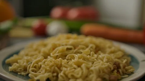Noodles and vegetables on kitchen table Vidéo 119956538