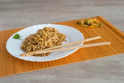 Noodles with beef in rectangle plate with bamboo stic 스톡 사진