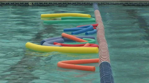 Noodles bobbing in a pool Stock Footage 98288
