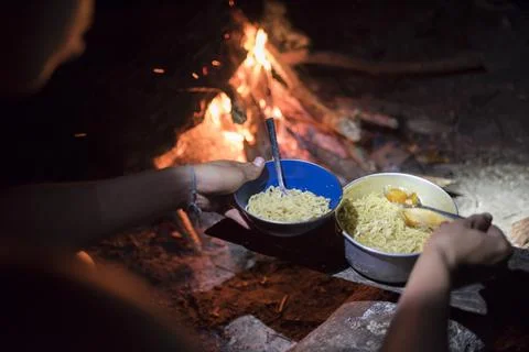 Noodles for dinner, cooked on a camp fire while camping on Marak Island, a Stock Photos