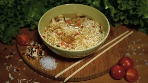 Noodles with dried vegetables prepare. Close up. Time-Lapse Stockbeeldmateriaal 73076738