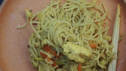 Noodles on plate overhead Stock Footage 98361216