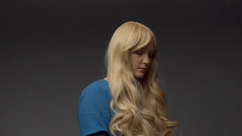 Nordic blond model in studio with dramatic top light. Blonde long hair Stock Footage 108614284