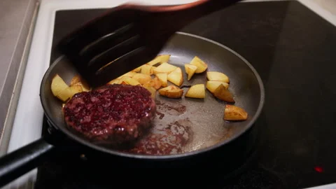 Nordic Burger Steak and Pan-Fried Potatoes on Induction Hob Stock Footage 345768249