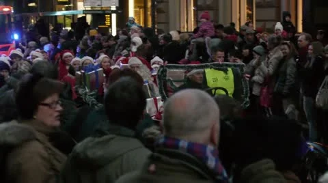 Nordic Santa Claus sitting on a jalopy waving to people on the street Video stock 12713402