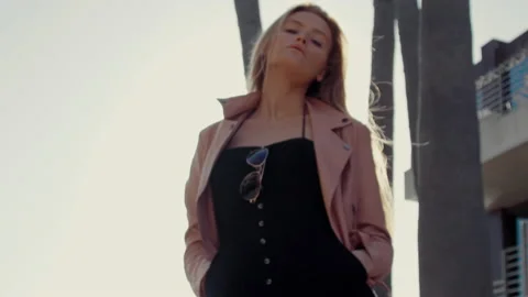 Nordic Woman looking at camera while posing over city background at sunset Stock-Footage 151221594