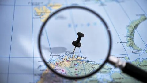 Nordkapp, a destination marked on a printed map with a magnifying glass Stock Photos