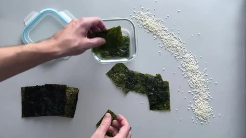 Nori chips are put in a container Stock Footage 256449630