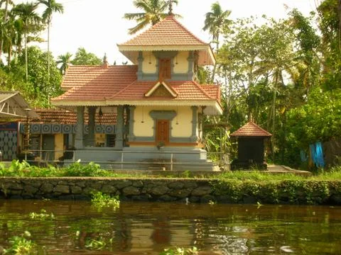 A  normal house with trees on riverfront Stock Photos