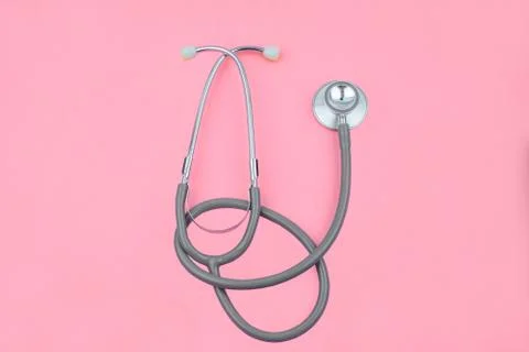 Normal image of one single normal stethoscope isolated on top of a pink color Stock Photos