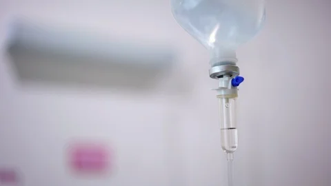 Normal saline solution or sodium chloride with infusion bottle drip for patient  Stock Footage 128411251