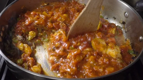 Normal speed and slow motion – Fish, vegetables and sauce stirring in frying pan Video stock 105075447