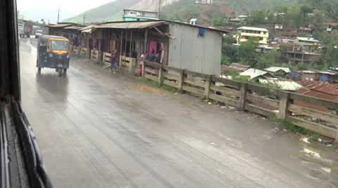 Normal traffic passes on a hilly highway in the rainy season near Imphal 動画素材 38118413