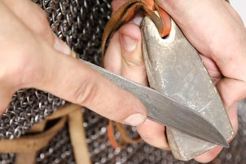Norman warrior 2nd half of the 11th century sharpens knife Stock Photos