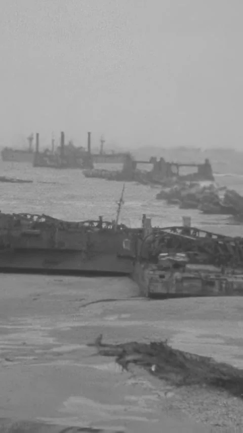 NORMANDY - 1944 - Panorama of US Army soldiers walking Omaha Beach surrounded by Stock Footage 340298971