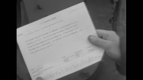 NORMANDY - 1944 - A sailor reads a telegram while on a ship off the Normandy Stock Footage 312794436