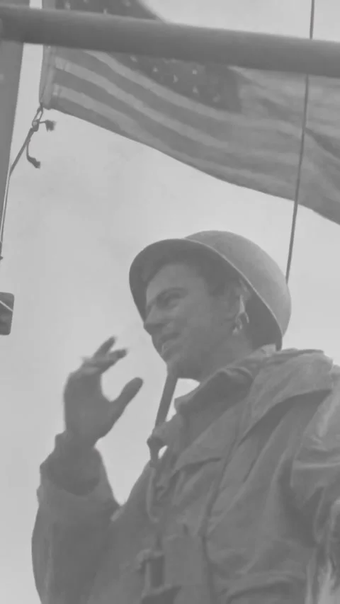NORMANDY - 1944 - A wounded US Army soldier is transferred to an LCVP, while Stock Footage 340307079