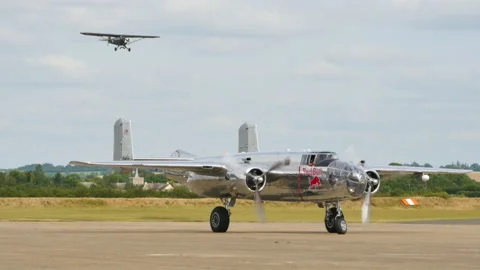North American B-25 Mitchell of Red Bull Flying Bulls parked with engine running Stock Footage 155974624