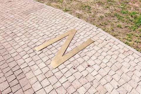 North direction marker on cobbled path in park Stock Photos
