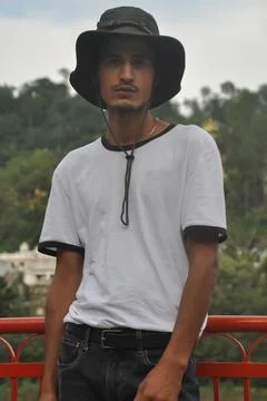 A north Indian young guy posing outdoor with wearing boonie hat and white tshirt Stock Photos