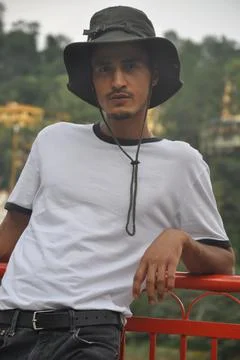 A north Indian young guy posing outdoor with wearing boonie hat and white tshirt Stock Photos