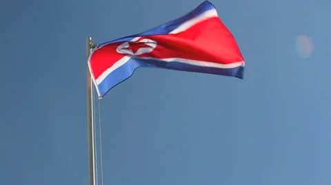 North Korea flag in front of blue sky Stock Footage