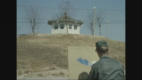 North Korean guard post building and artist working on canvas - 1970 Vídeos de archivo 96330078