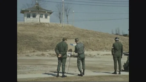 North Korean guard post building and artists working on canvas - 1970 Vídeos de archivo 96330082