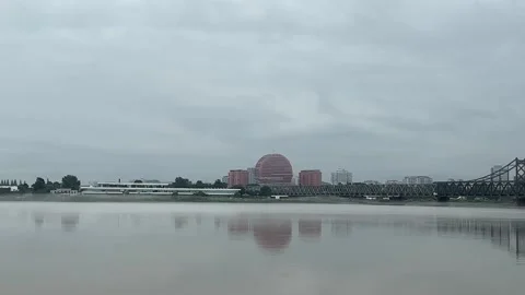 North Korean Riverfront and Border Bridge Seen from Dandong China Stock Footage 340176040