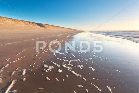 North sea beach at sunset Stock Photos