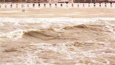 North sea by high tide : waves, beach and cabins shooted from a pier Stock Footage 89656301