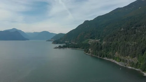 North Vancouver lateral move from water over mountain highway Stock Footage