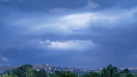 NORTHCLIFF THUNDER CLOUDS pan Left along mountain with trees moving in the wind Stock Footage 98843040