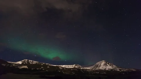 Northern light in starry sky over the snow covered mountains Stock Footage 73011289