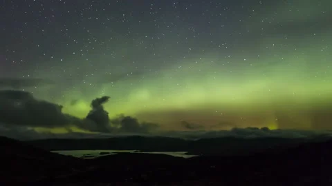 Northern Lights and dramatic clouds over mountain landscape Stock Footage 205388835