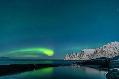 Northern lights, Aurora Borealis, Devil Teeth mountains in the background Stock Photos