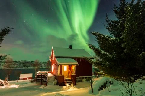 Northern lights Aurora Borealis in the night above a typically artic style .. Stock Photos