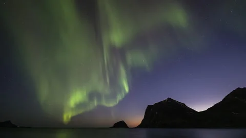 Northern Lights dancing over mountain in coast area Stock Footage 251360700