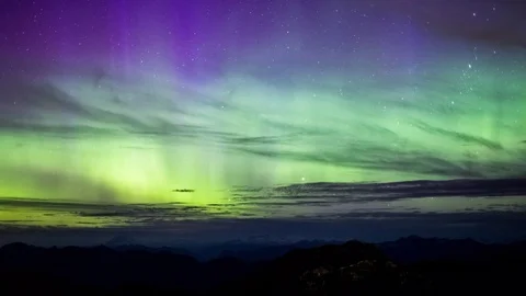 Northern Lights Dancing in the Sky Over Distant Mountains Stock Footage 73240819