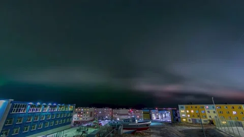 Northern lights with flying clouds over the polar city. Time Laps Stock Footage 195987158