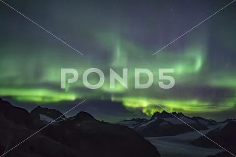 Northern Lights glowing over the Juneau Icefield, Tongass National Forest Stock Photos
