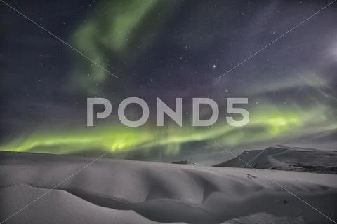 Northern Lights Or Aurora Borealis Above The Snow Covered Tundra Along The
