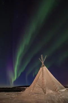 Northern lights over a traditional sami tipi in Northern Norway. Stock Photos